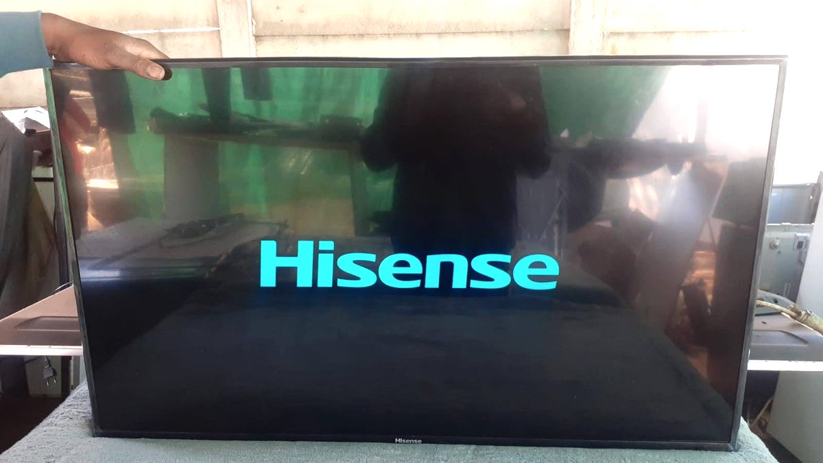 Television screen showing the manufacturer logo while powering on